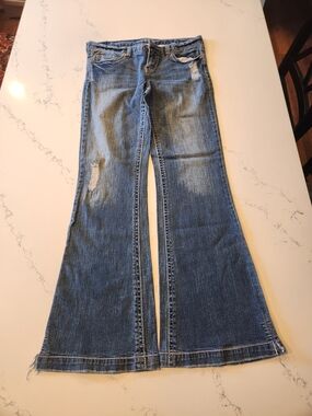 Vintage Vanity Medium Blue Flare Jeans with Distressed Accents